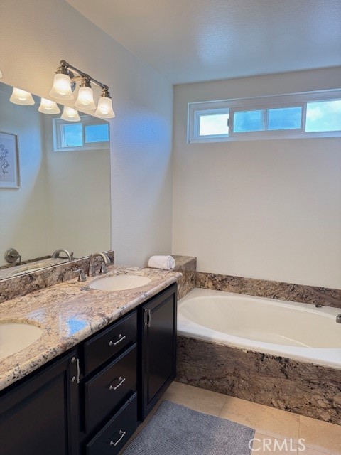 24 Carver Irvine, CA 92620 - Photo 15 of 18 a bathroom with a granite countertop sink and a mirror