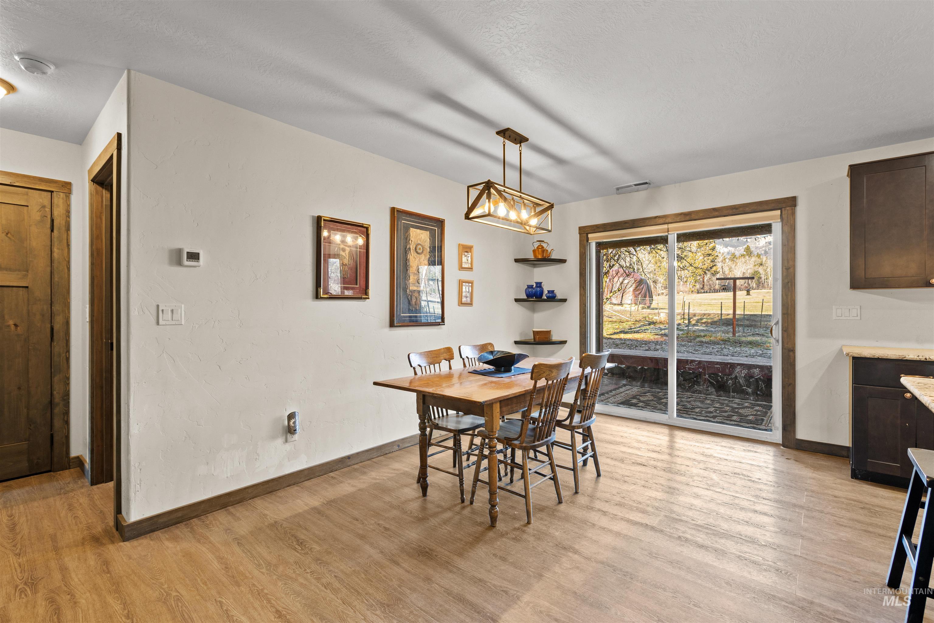 3488 Ward Road Cambridge, ID 83610 - Photo 13 of 49 Dining area with light wood-style flooring and a textured wall