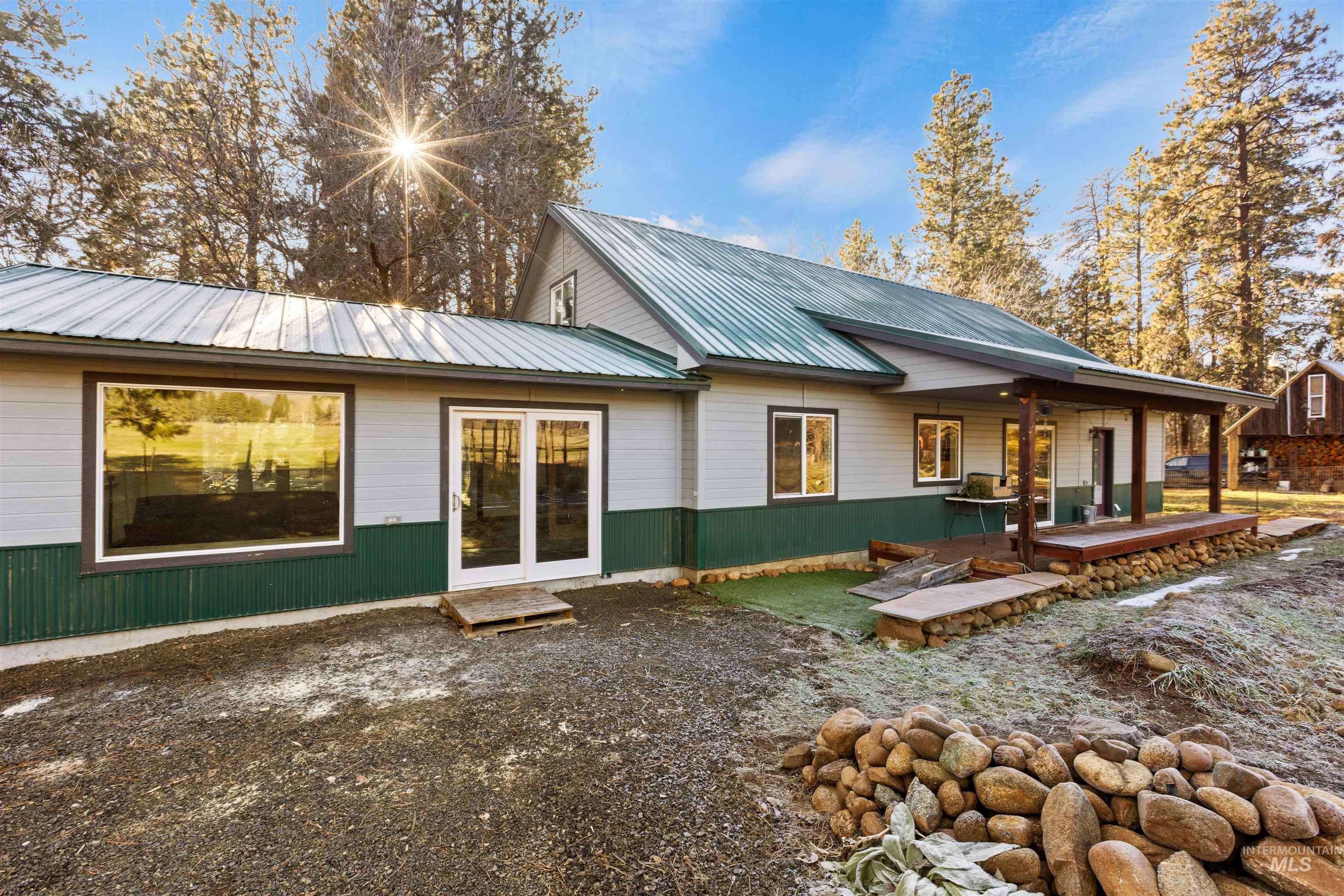3488 Ward Road Cambridge, ID 83610 - Photo 34 of 49 Rear view of house featuring a metal roof and covered porch