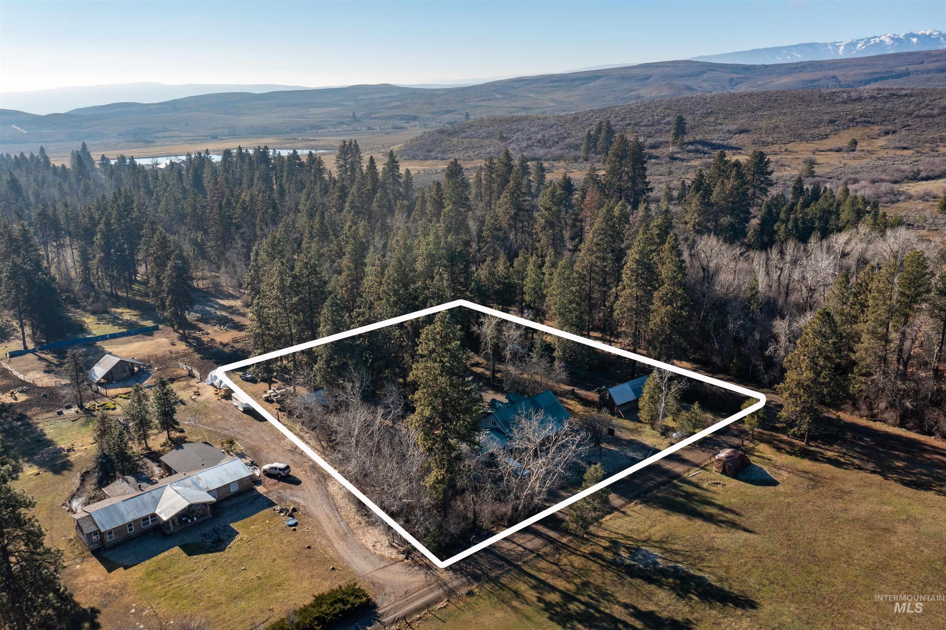 3488 Ward Road Cambridge, ID 83610 - Photo 46 of 49 Aerial overview of property's location featuring a mountain backdrop and property boundaries highlighted