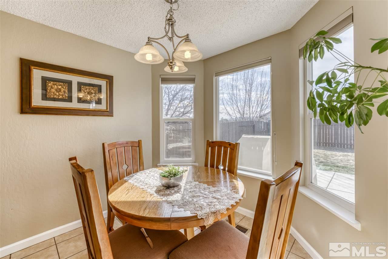 6282 Chesterfield Lane Reno, NV 89523 - Photo 15 of 34 a view of a dining room with furniture window and wooden floor