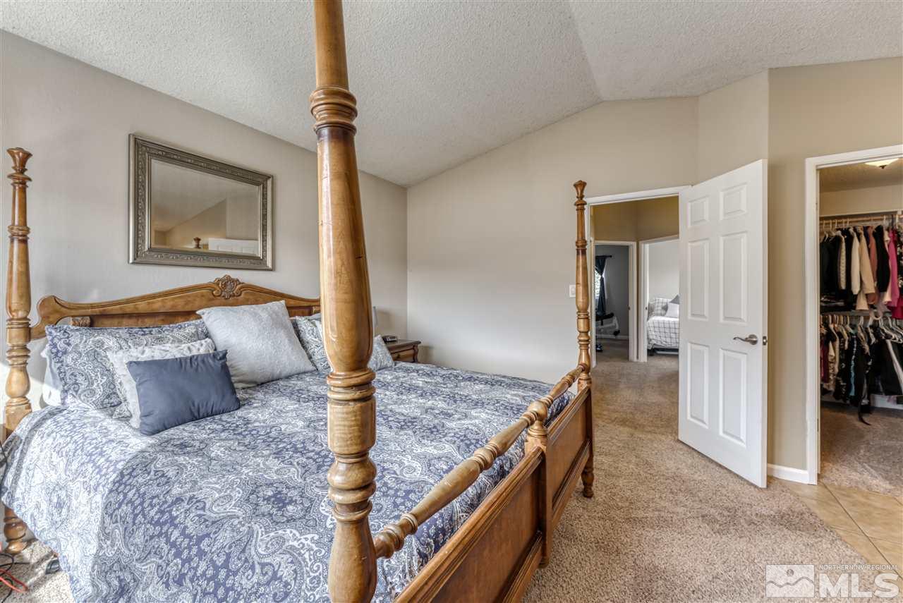 6282 Chesterfield Lane Reno, NV 89523 - Photo 17 of 34 a bedroom with a large bed and a wooden floor