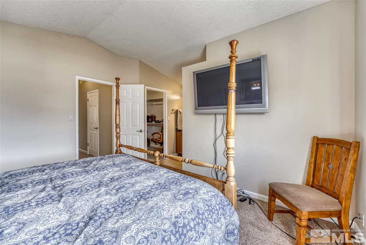 6282 Chesterfield Lane Reno, NV 89523 - Photo 18 of 34 a bedroom with a bed and a chair
