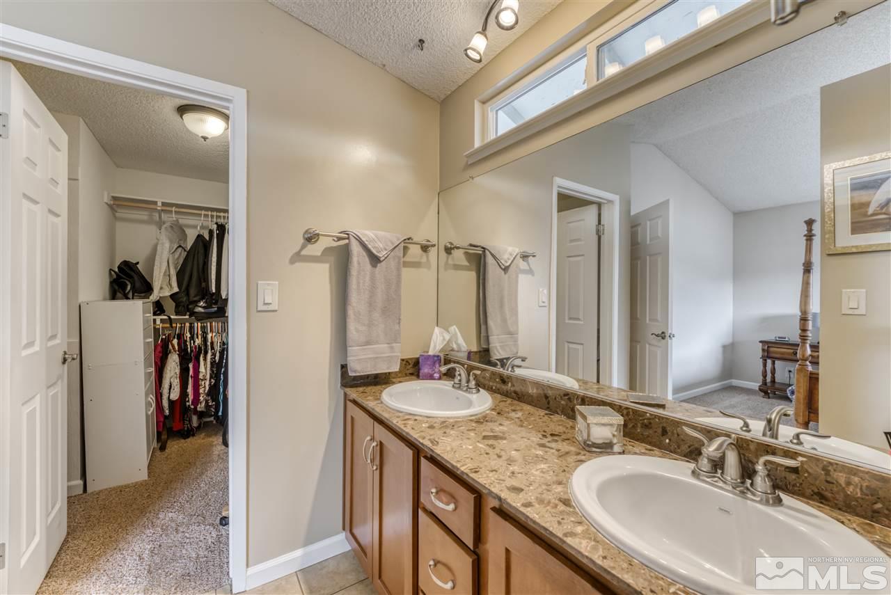 6282 Chesterfield Lane Reno, NV 89523 - Photo 20 of 34 a bathroom with a granite countertop sink a mirror and a shower