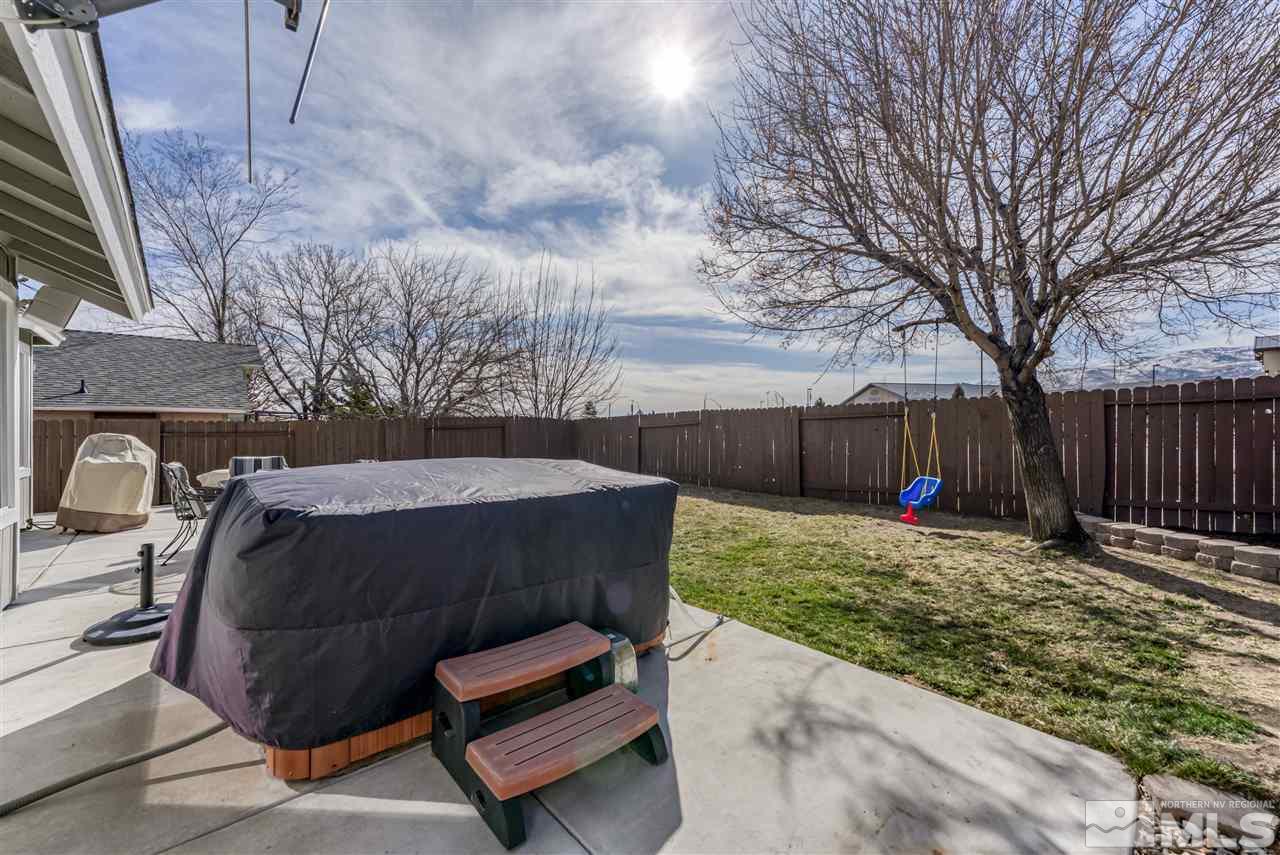 6282 Chesterfield Lane Reno, NV 89523 - Photo 34 of 34 a view of backyard with table and chairs a wooden fence and trees