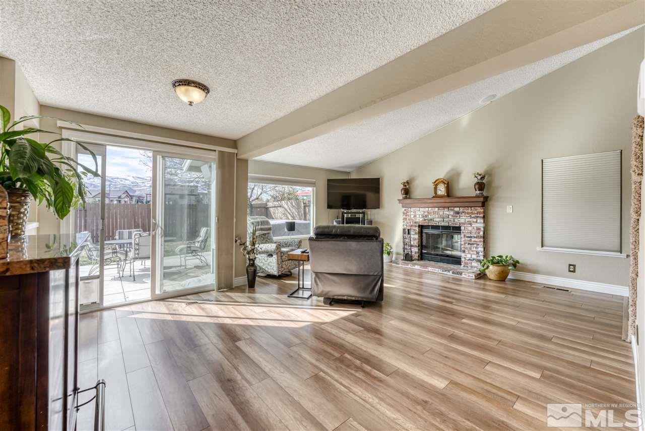 6282 Chesterfield Lane Reno, NV 89523 - Photo 8 of 34 a living room with furniture a fireplace and a flat screen tv