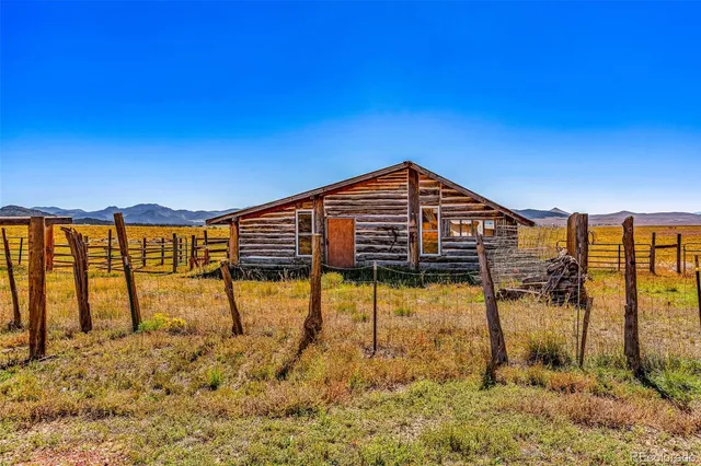 a view of a swimming pool with a chair and floor to ceiling window