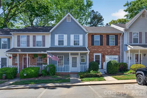 a front view of a house with yard and green space