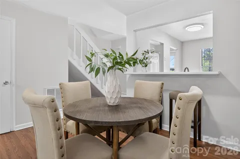 a view of a dining room with furniture and a potted plant
