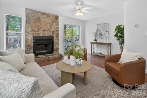 a living room with furniture a fireplace and a window