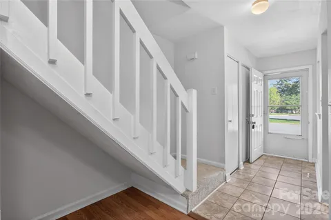 a view of staircase with white walls and windows