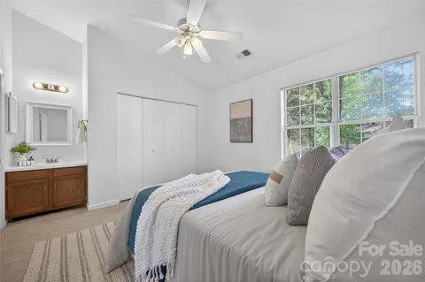 a bedroom with a large bed and a chandelier