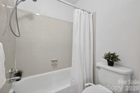 a bathroom with a toilet and a bathtub
