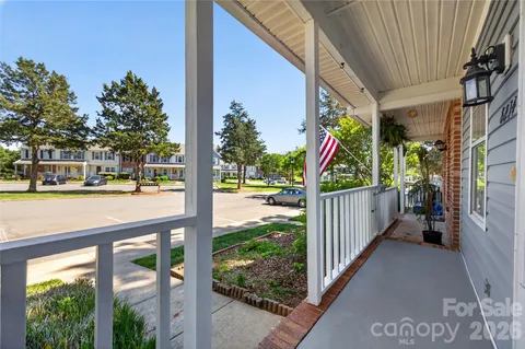 a view of a porch with wooden floor and fence