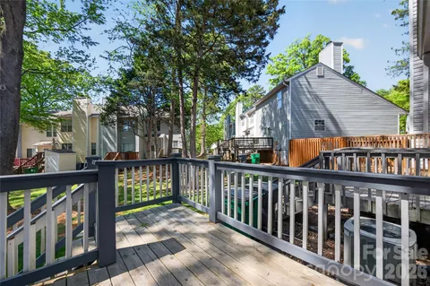 a view of wooden deck and a backyard