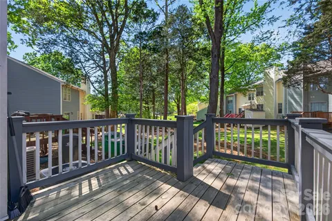 a view of balcony with wooden floor and fence