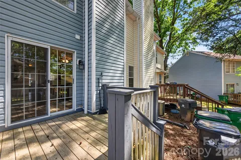 a view of a house with backyard and deck