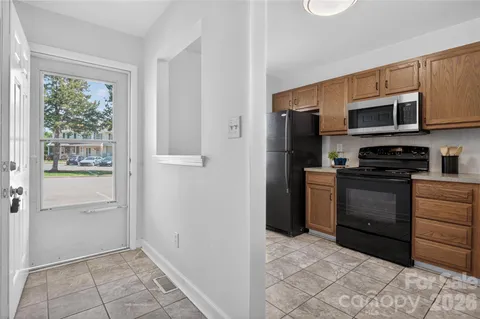a kitchen with stainless steel appliances granite countertop a refrigerator and a stove