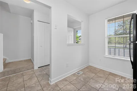 an empty room with windows and closet