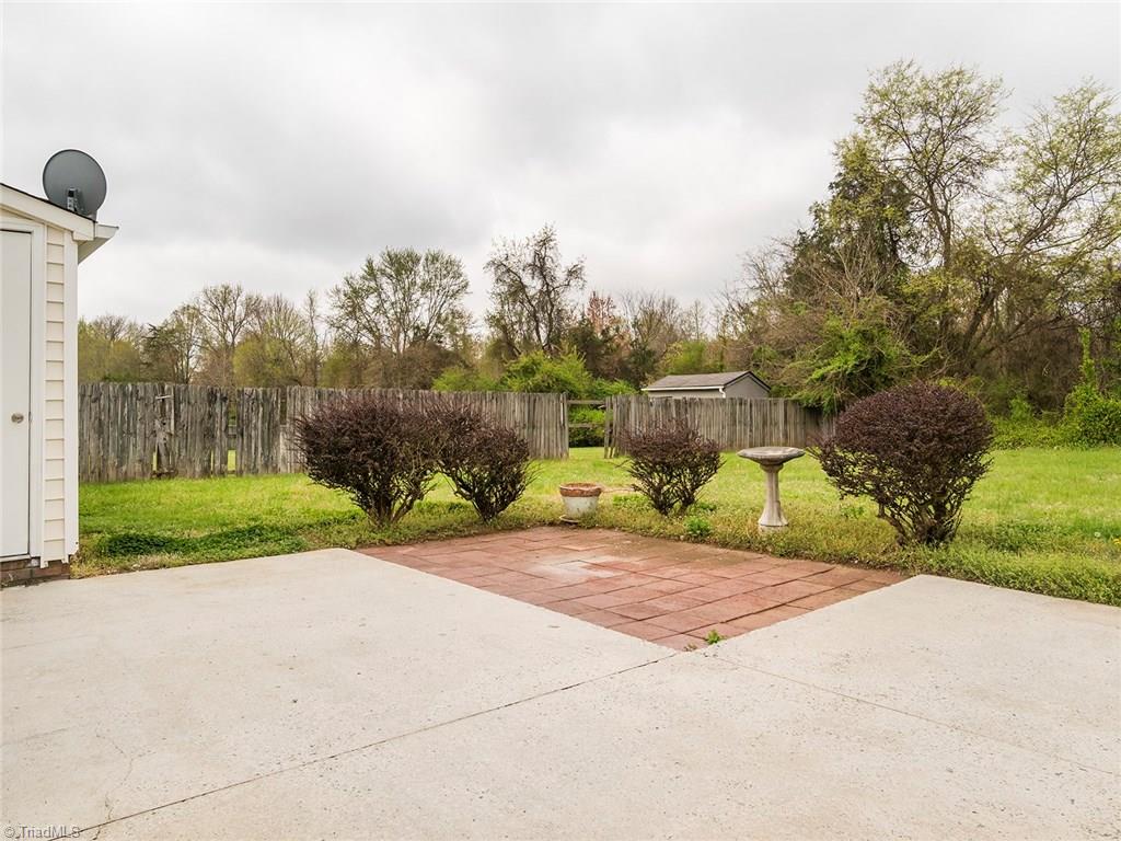 3621 Country Ridge Road Greensboro, NC 27405 - Photo 22 of 24 Back yard with storage closet and patio area.
