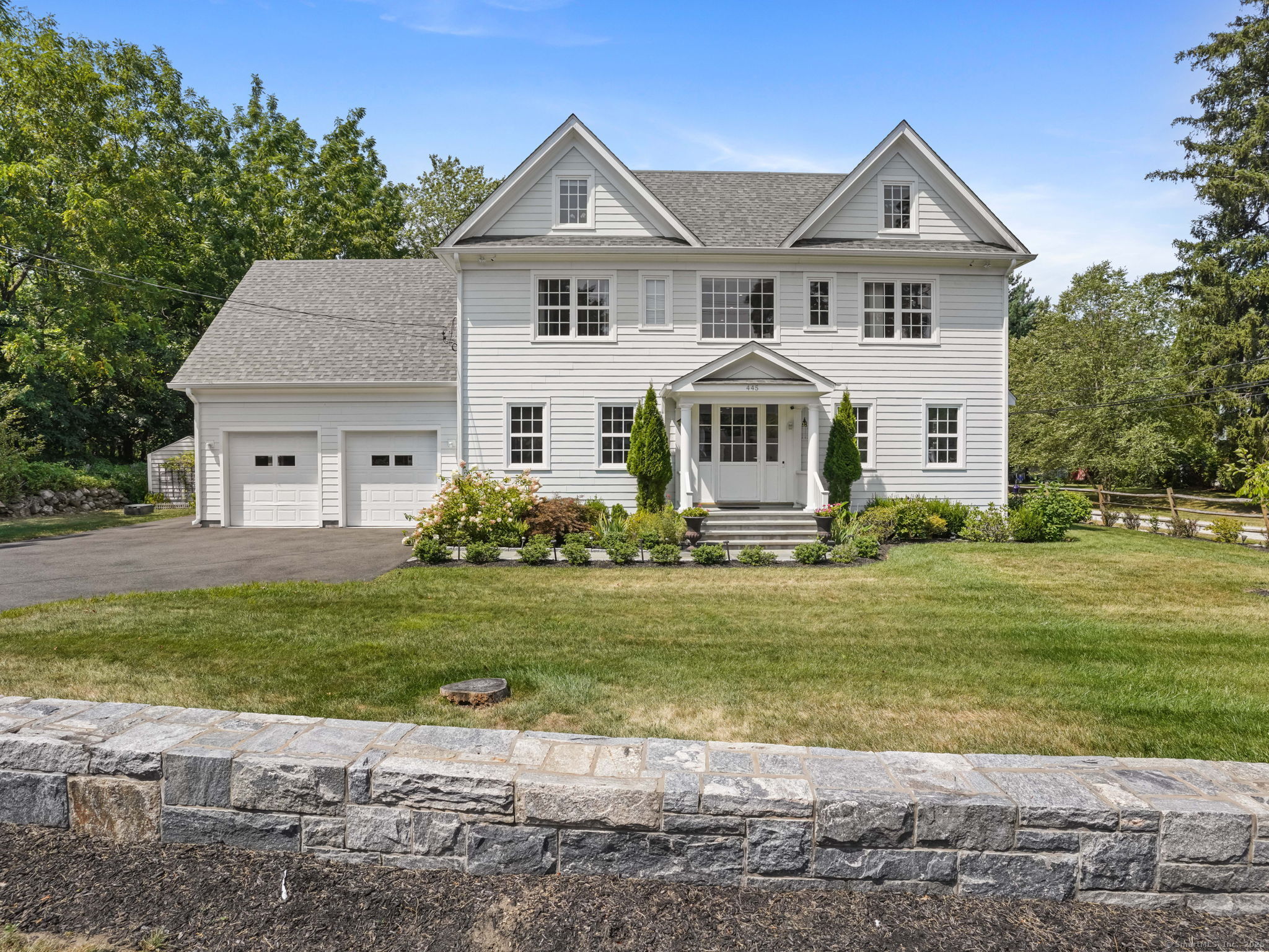445 Flax Hill Road Norwalk, CT 06854 - Photo 1 of 1 a front view of a house with a garden