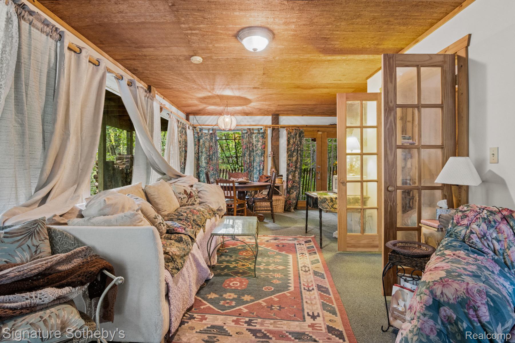 11436 Lakeview Road Northeast Kalkaska, MI 49646 - Photo 20 of 29 Carpeted living room featuring french doors and wooden ceiling