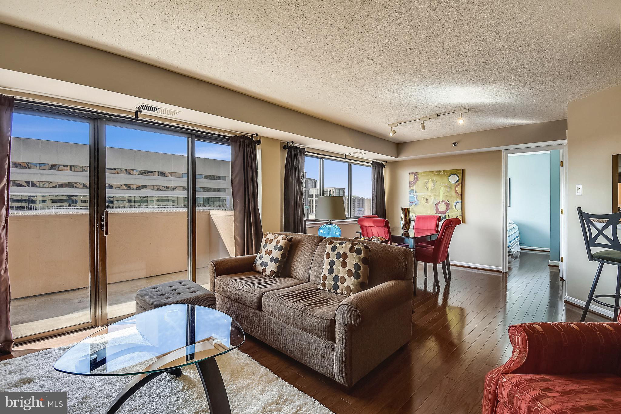 1301 North Courthouse Road, Unit 1503 Arlington, VA 22201 - Photo 1 of 26 a living room with furniture and a large window