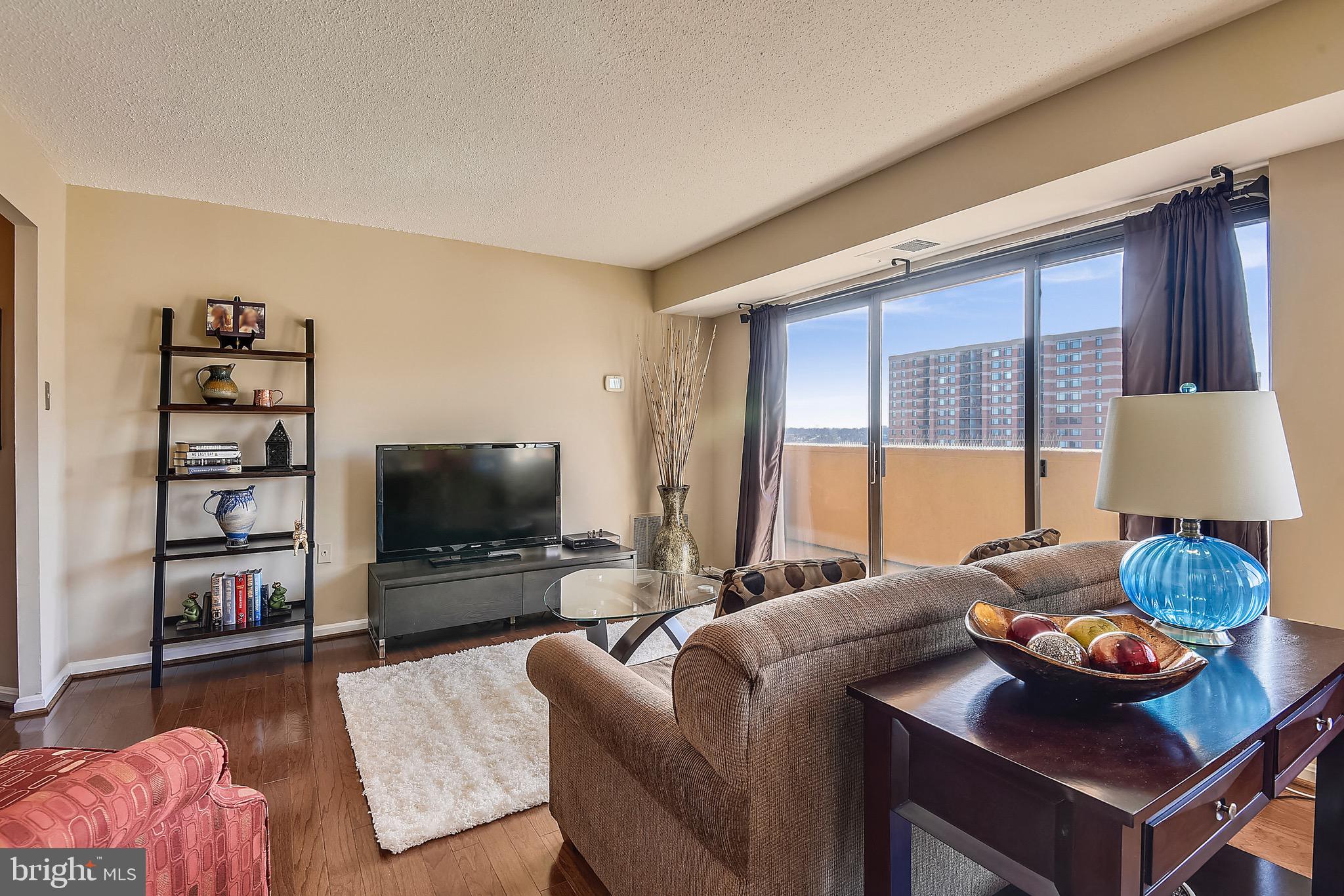 1301 North Courthouse Road, Unit 1503 Arlington, VA 22201 - Photo 12 of 26 a living room with furniture and a flat screen tv