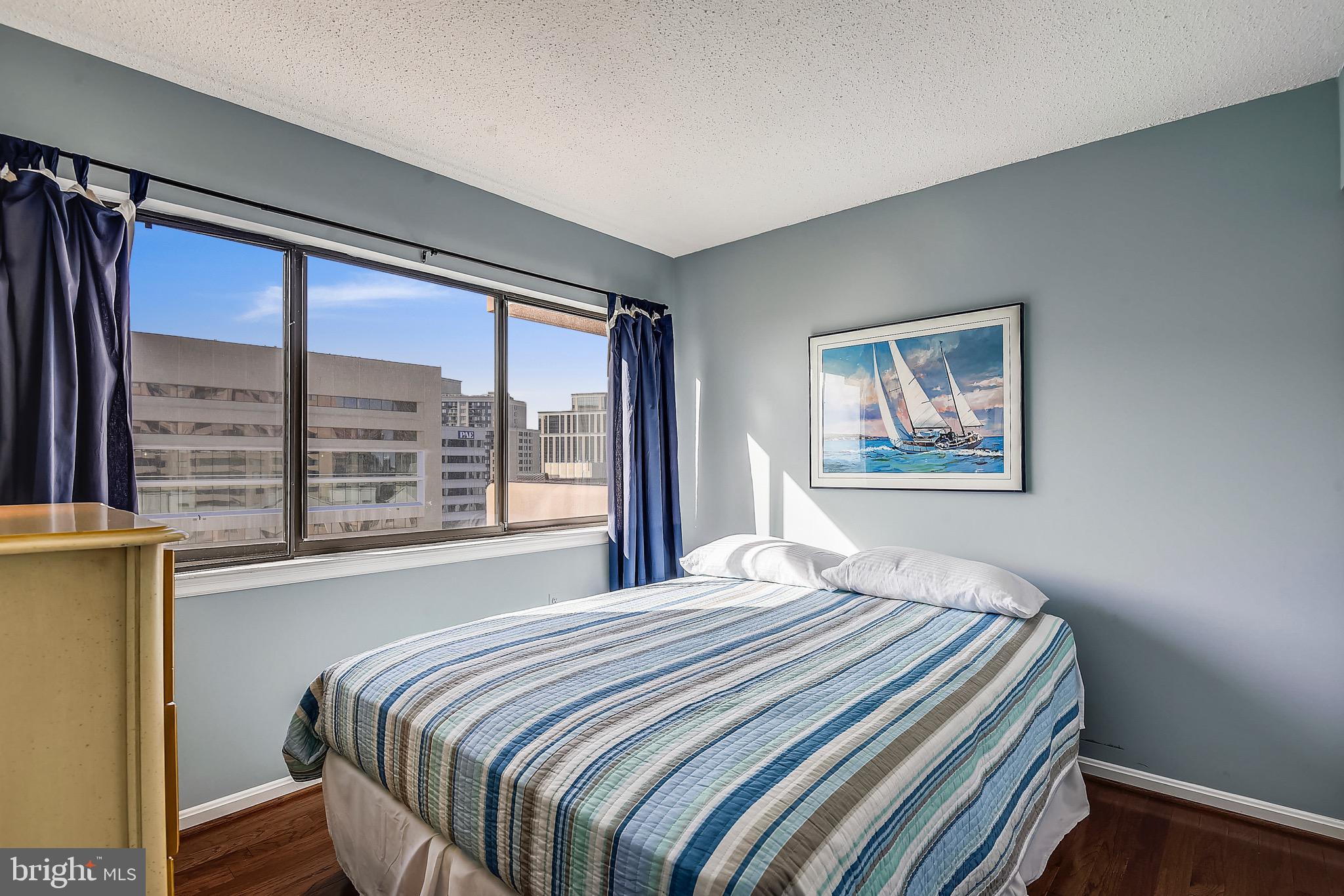 1301 North Courthouse Road, Unit 1503 Arlington, VA 22201 - Photo 8 of 26 a bedroom with a bed and a large window