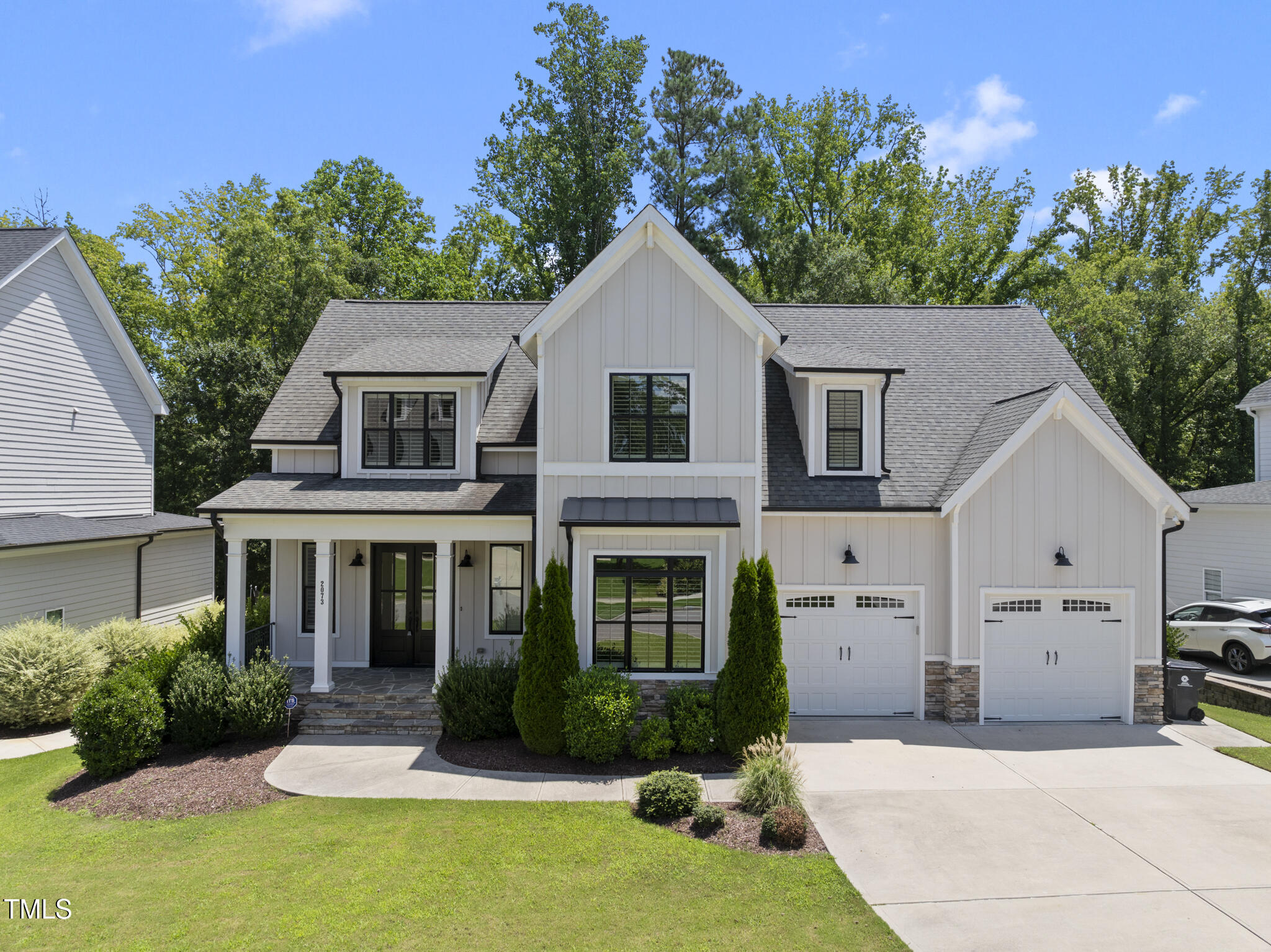 2073 Amalfi Place Apex, NC 27502 - Photo 1 of 40 a front view of a house with a yard and garage