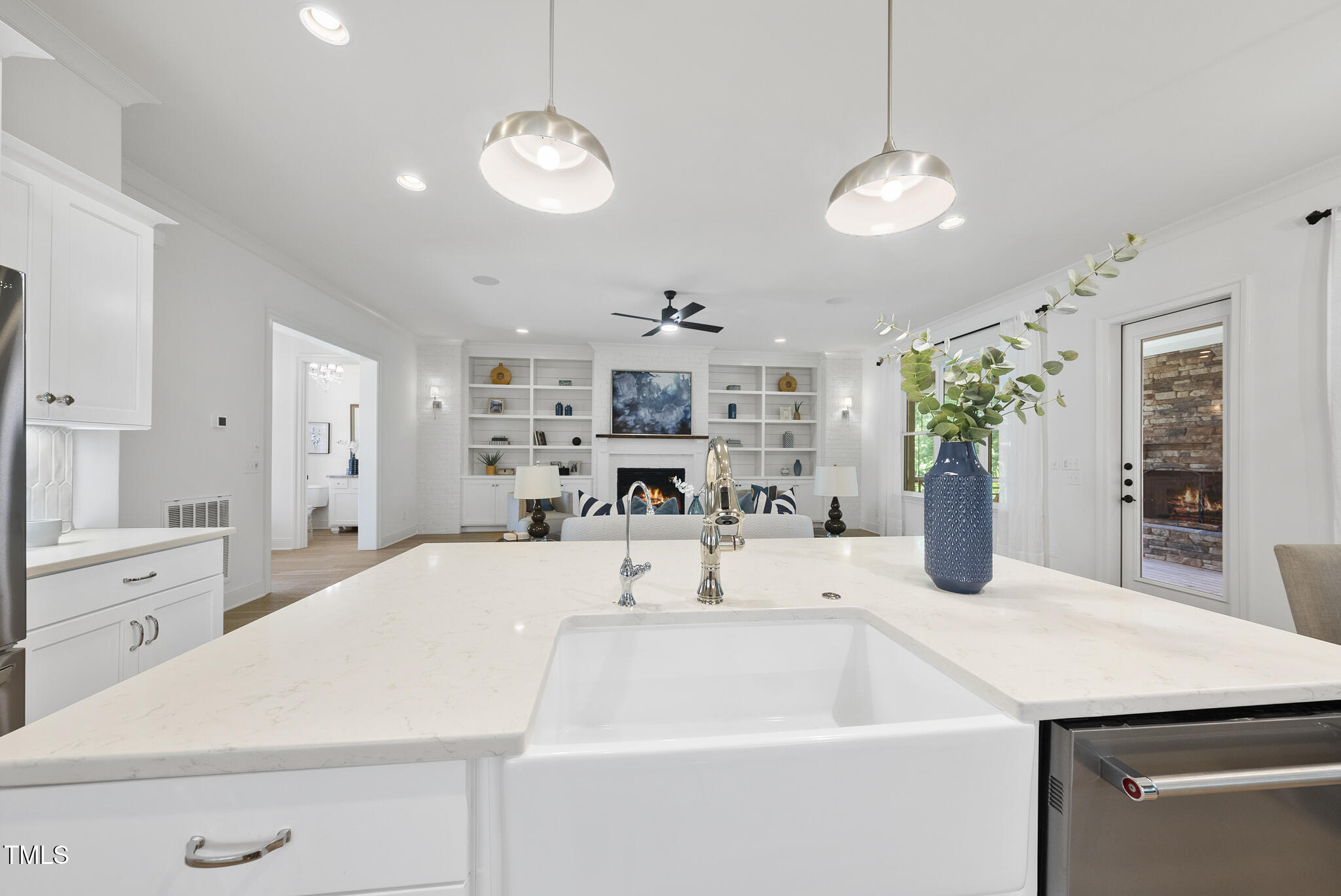2073 Amalfi Place Apex, NC 27502 - Photo 12 of 40 a kitchen with a sink a chandelier and wooden floor