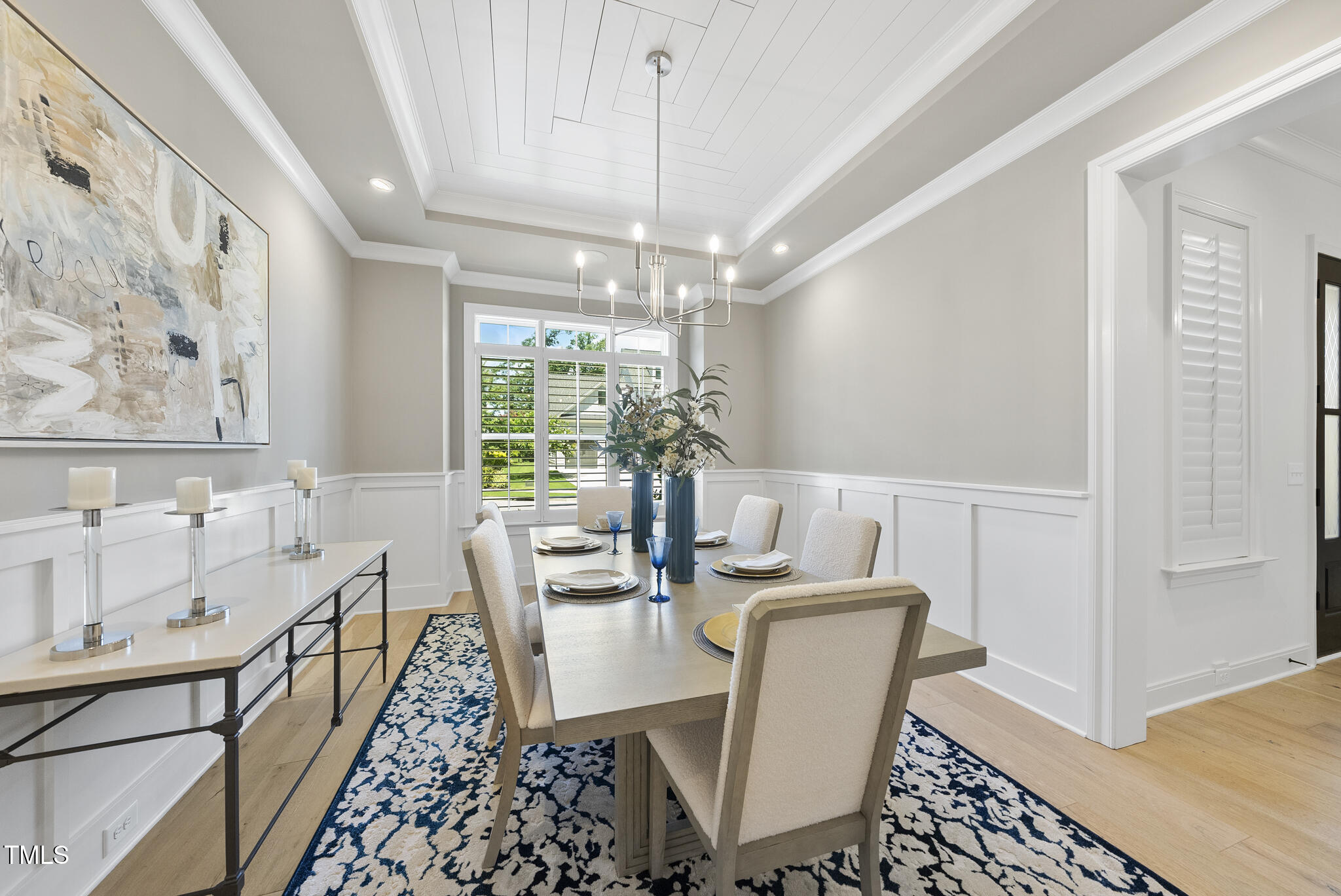 2073 Amalfi Place Apex, NC 27502 - Photo 13 of 40 a dining room with furniture a chandelier and wooden floor