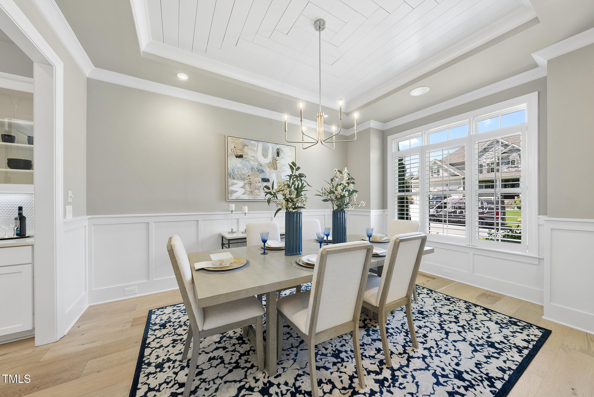 2073 Amalfi Place Apex, NC 27502 - Photo 14 of 40 a view of a dining room with furniture wooden floor and chandelier