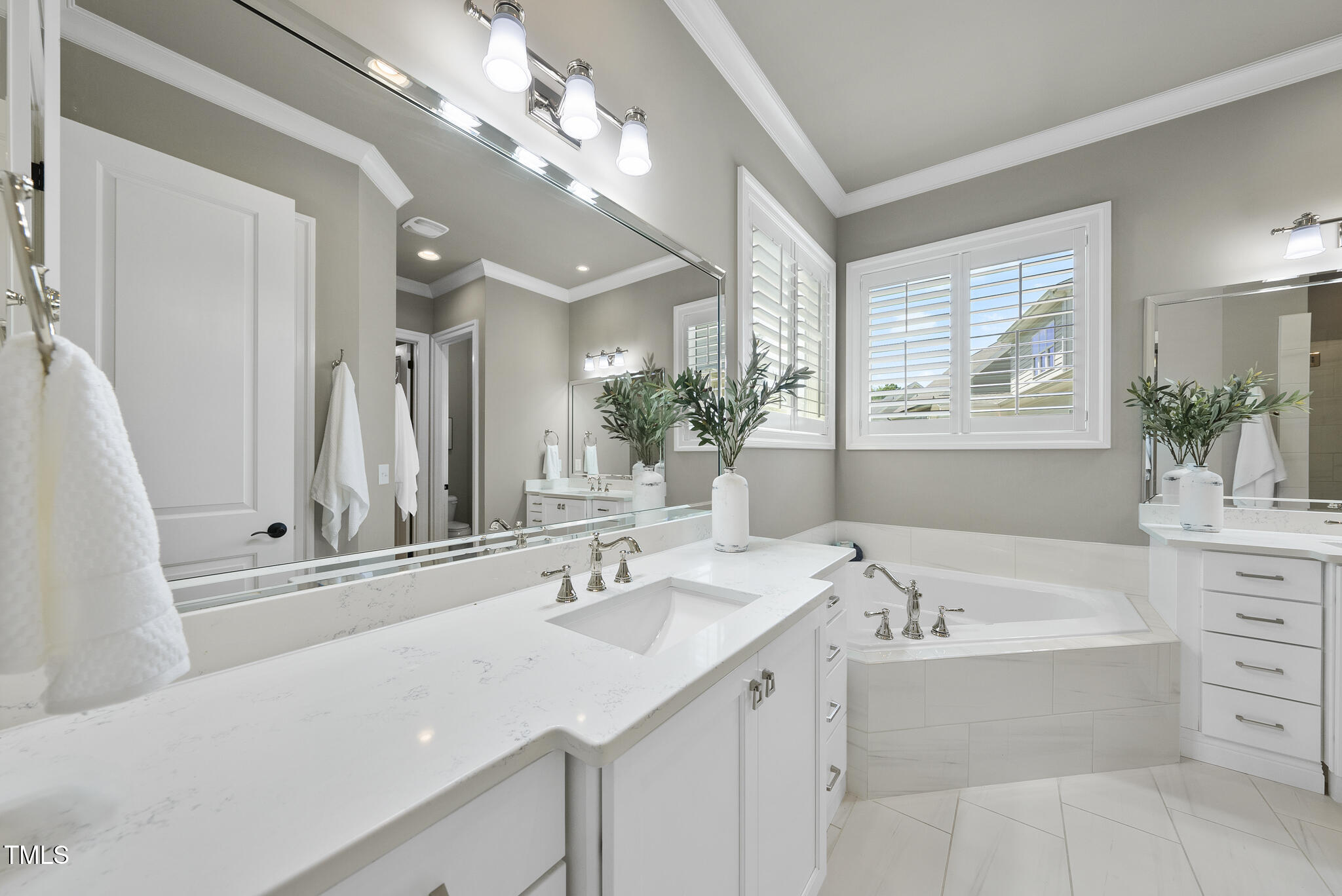 2073 Amalfi Place Apex, NC 27502 - Photo 20 of 40 a bathroom with a tub sink and mirror