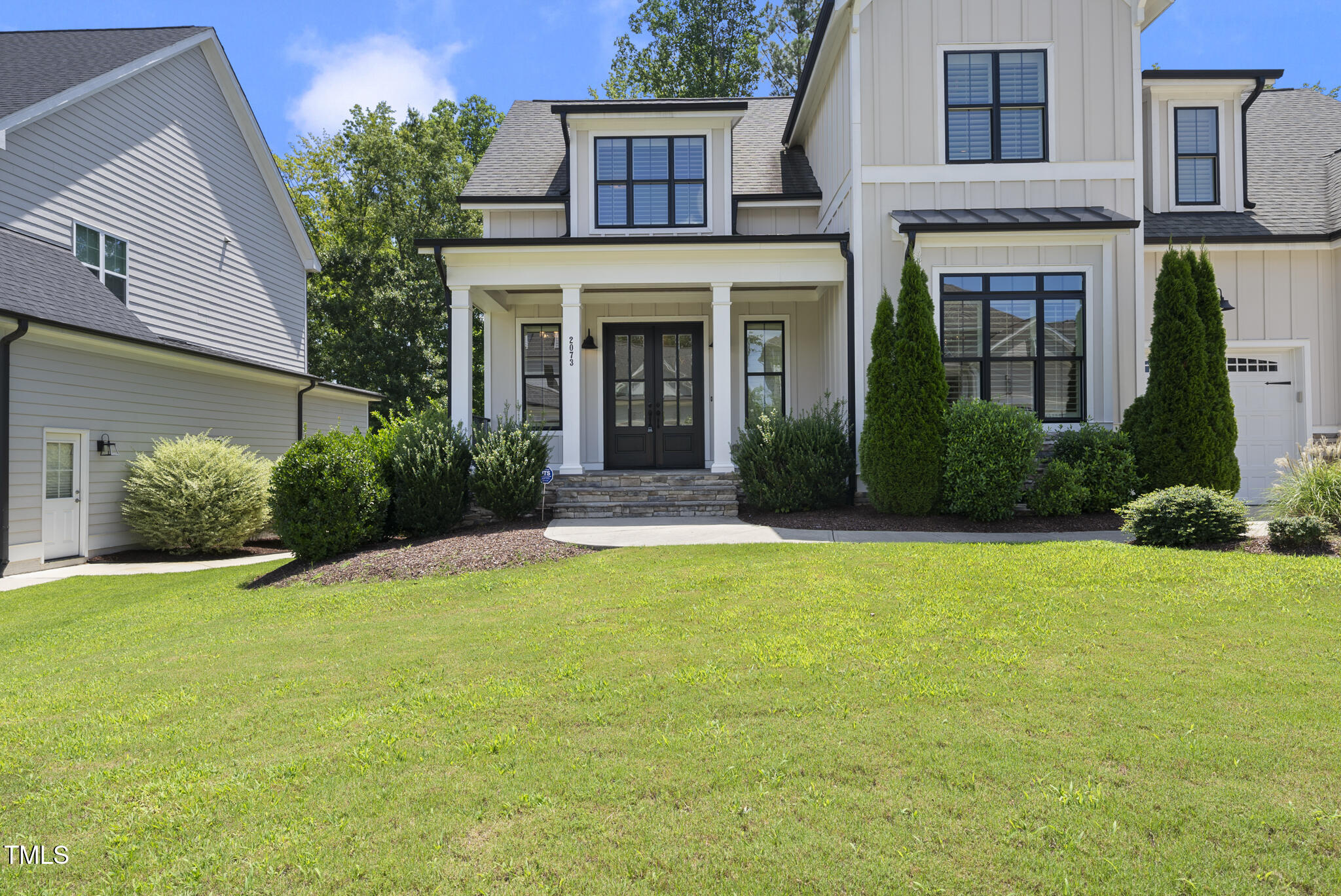 2073 Amalfi Place Apex, NC 27502 - Photo 34 of 40 a front view of a house with a yard and garage