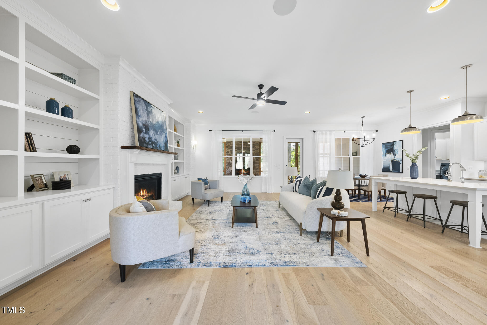 2073 Amalfi Place Apex, NC 27502 - Photo 4 of 40 a living room with furniture and a fireplace