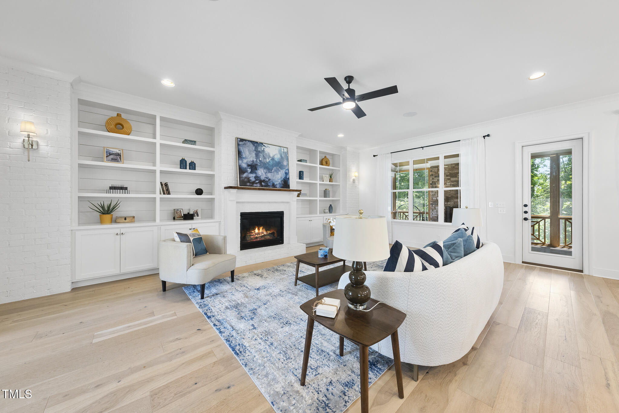 2073 Amalfi Place Apex, NC 27502 - Photo 5 of 40 a living room with furniture a fireplace and a flat screen tv