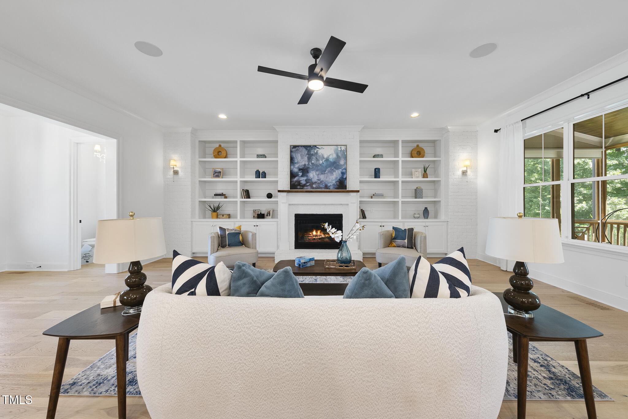 2073 Amalfi Place Apex, NC 27502 - Photo 6 of 40 a living room with furniture a fireplace and a flat screen tv