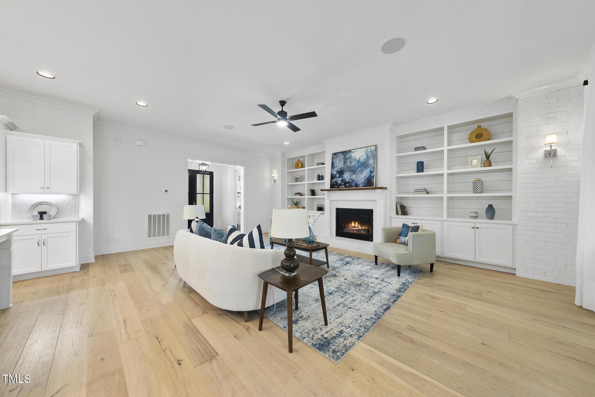 2073 Amalfi Place Apex, NC 27502 - Photo 7 of 40 a living room with furniture a fireplace and a table