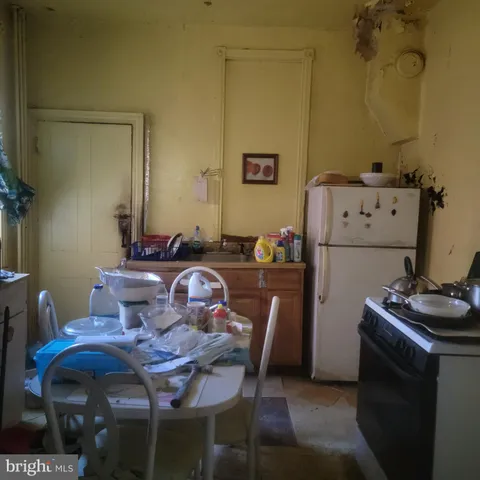 a dining room with furniture a refrigerator and a table