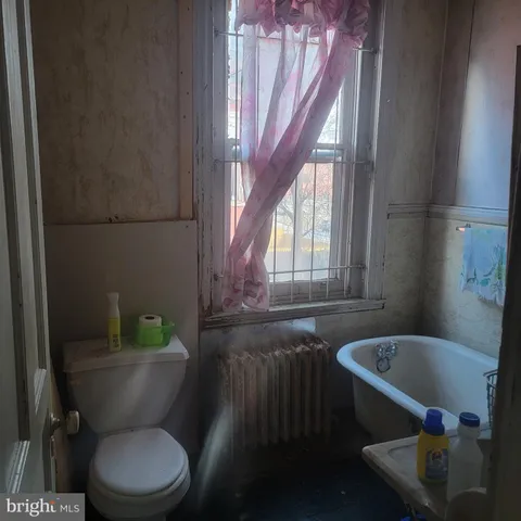 a bathroom with a toilet a sink and bathtub