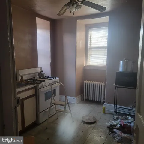 a kitchen with furniture and a stove