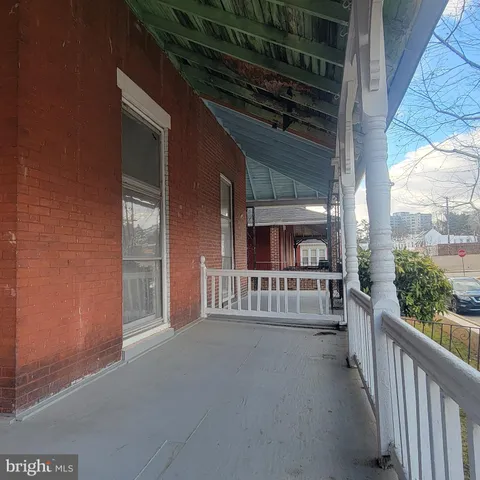 a view of a house with porch and wooden floor