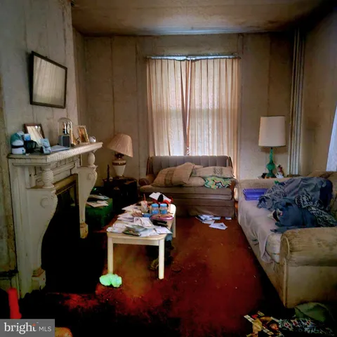 a living room with furniture and a lamp