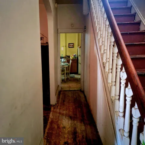 a view of hallway with wooden floor and stairs