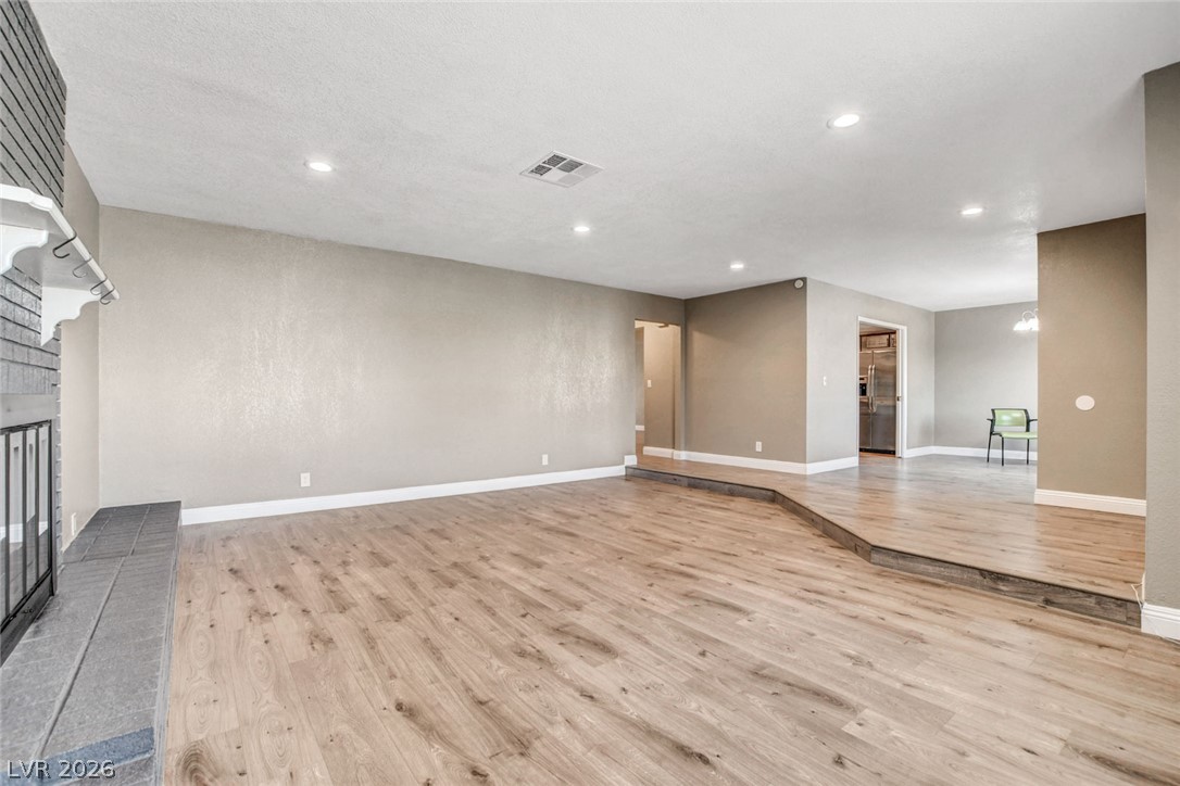 4367 South Mojave Road Las Vegas, NV 89121 - Photo 9 of 53 A split-level layout with a fireplace creates a dynamic and inviting living space.
