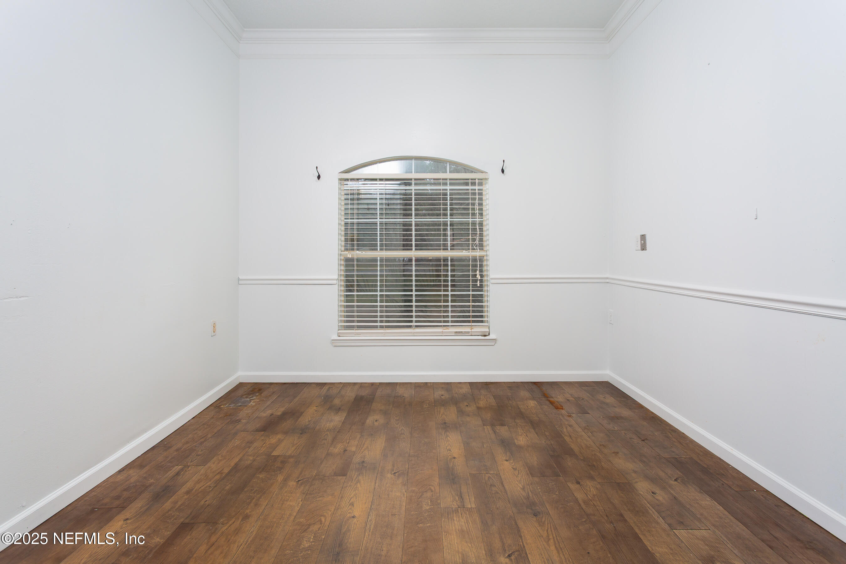 164 Carole Road Palatka, FL 32177 - Photo 13 of 32 a view of an empty room with wooden floor and a window