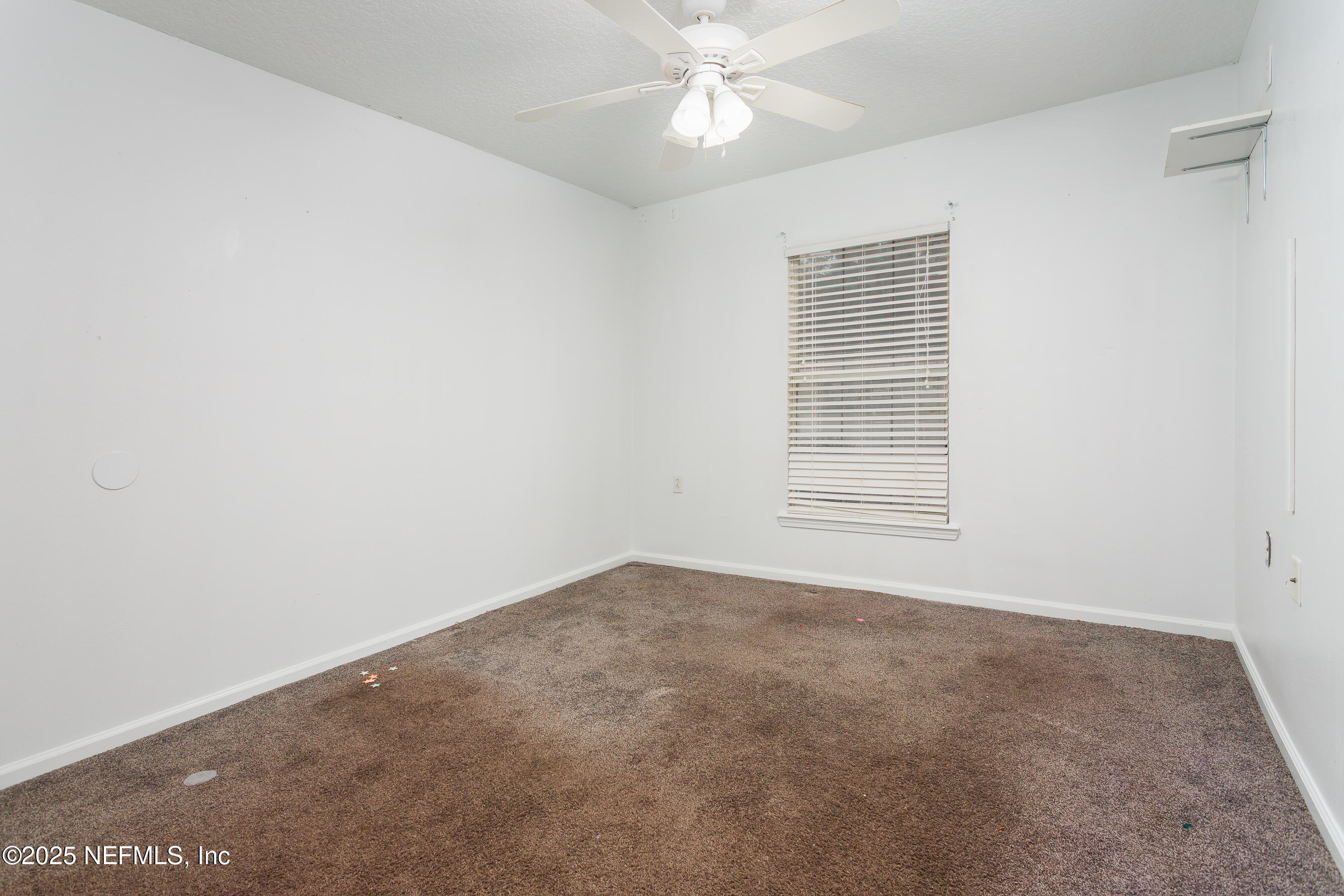 164 Carole Road Palatka, FL 32177 - Photo 14 of 32 an empty room with a window and a ceiling fan