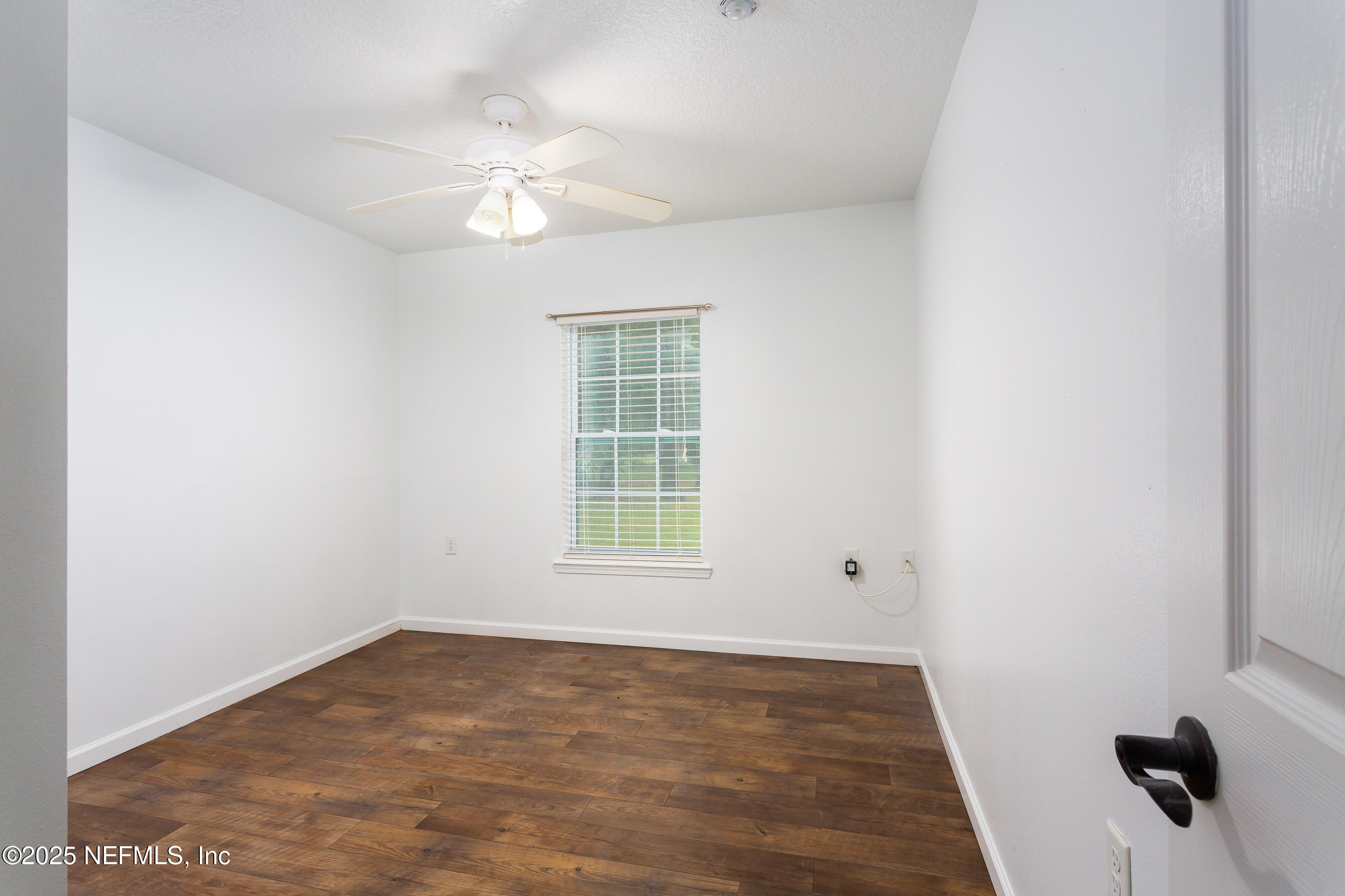 164 Carole Road Palatka, FL 32177 - Photo 20 of 32 wooden floor in an empty room with a window