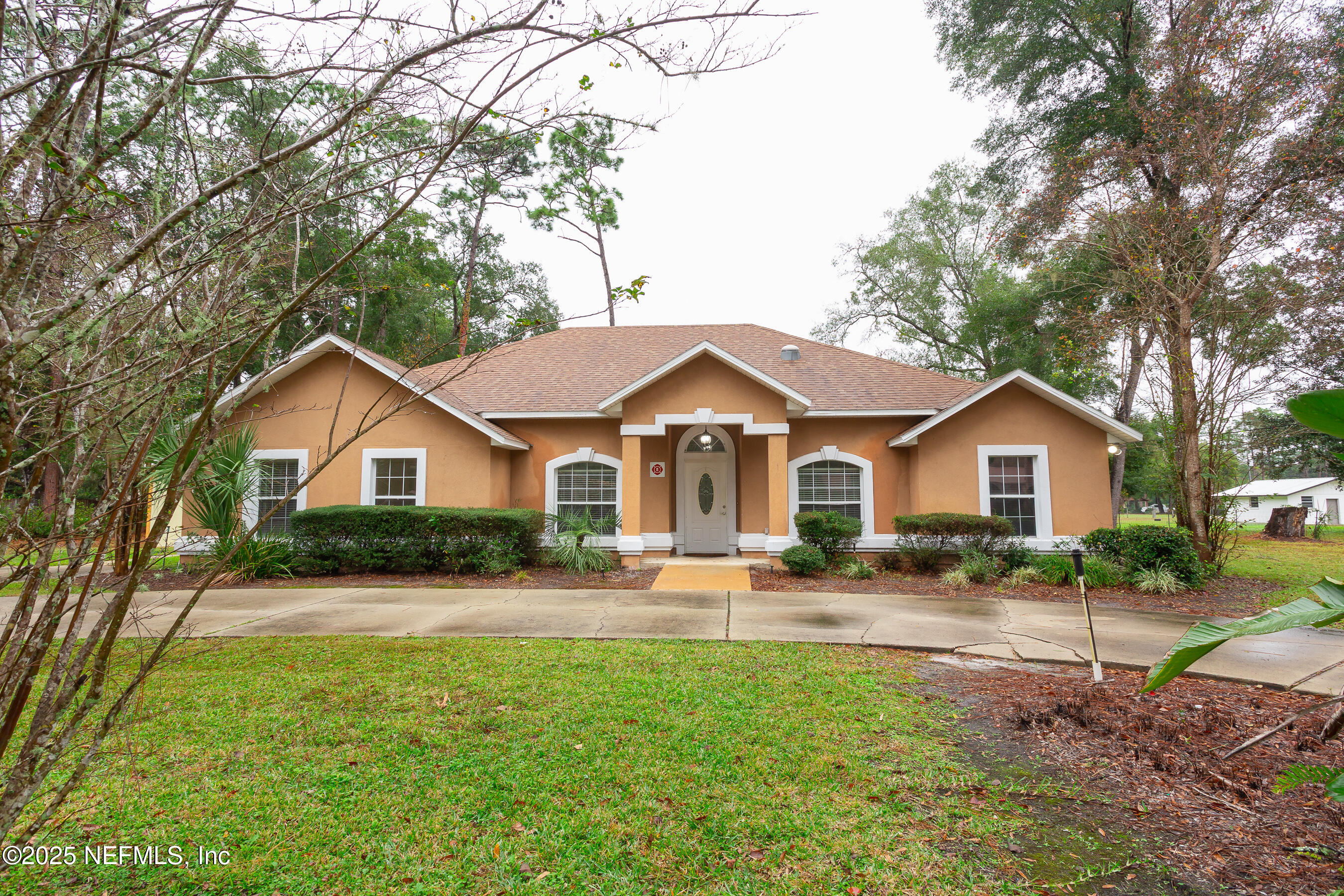 164 Carole Road Palatka, FL 32177 - Photo 29 of 32 a front view of a house with a yard and garage